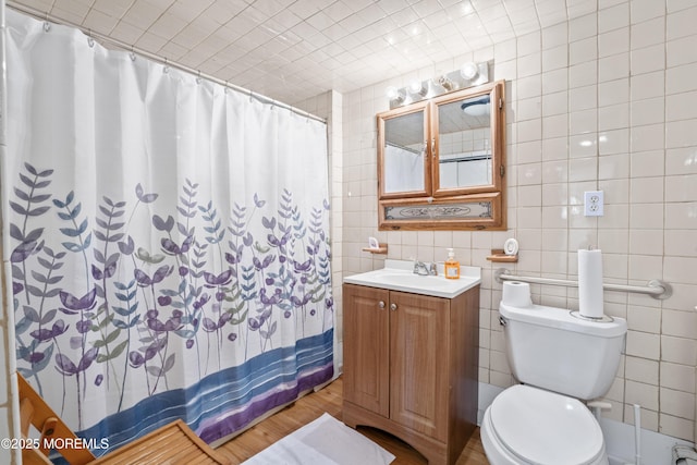 1920 W Lake Ave, Neptune Township, NJ 07753 - full bathroom featuring vanity, toilet, tile walls, and wood finished floors