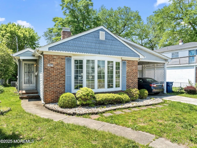 1920 W Lake Ave, Neptune Township, NJ 07753 - view of front of property featuring a chimney, an attached carport, brick siding, concrete driveway, and a front yard