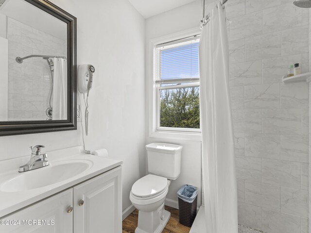 305 Franklin Ave, Seaside Heights, NJ 08751 - bathroom with vanity, tiled shower, toilet, and wood finished floors