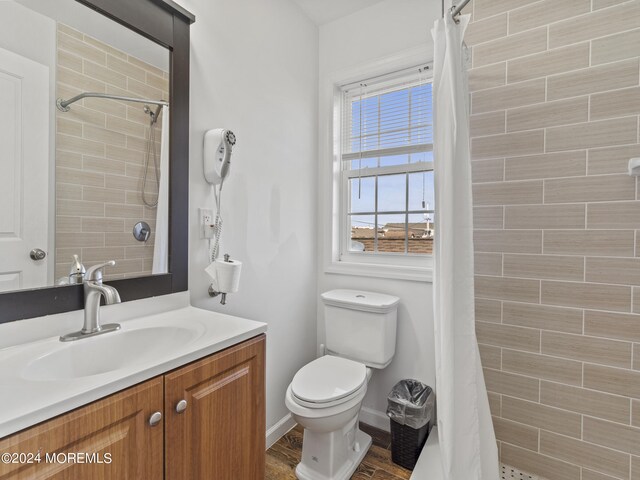 305 Franklin Ave, Seaside Heights, NJ 08751 - bathroom with vanity, toilet, a tile shower, and wood finished floors