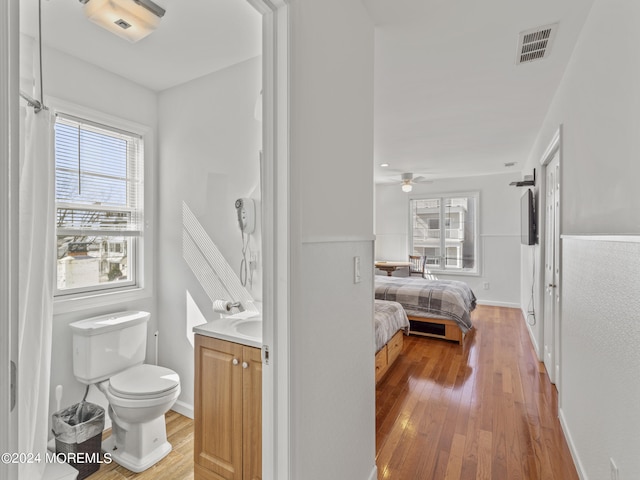 305 Franklin Ave, Seaside Heights, NJ 08751 - bathroom featuring vanity, wood finished floors, toilet, and healthy amount of natural light