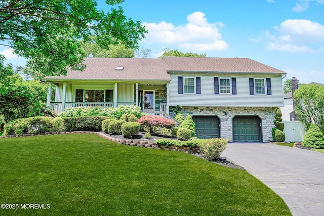 35 High Ridge Rd, Ocean Twp, NJ 07712 - tri-level home featuring an attached garage, asphalt driveway, stone siding, and covered porch