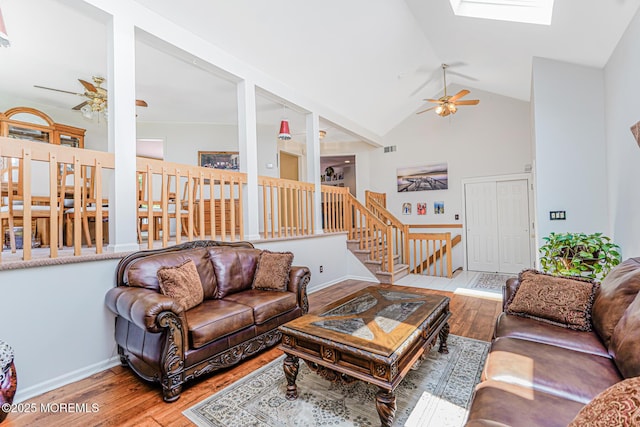 35 High Ridge Rd, Ocean Twp, NJ 07712 - living room featuring ceiling fan, hardwood / wood-style flooring, a skylight, high vaulted ceiling, and stairs