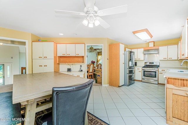 35 High Ridge Rd, Ocean Twp, NJ 07712 - kitchen with stainless steel appliances, range hood, ceiling fan, and white cabinets