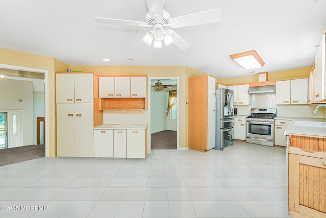 35 High Ridge Rd, Ocean Twp, NJ 07712 - kitchen with stainless steel appliances, range hood, light countertops, ceiling fan, and white cabinetry