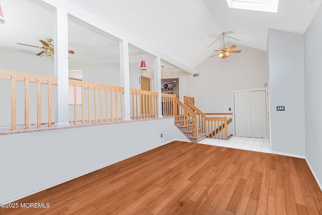35 High Ridge Rd, Ocean Twp, NJ 07712 - empty room featuring ceiling fan, a skylight, wood finished floors, high vaulted ceiling, and stairway