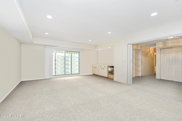 35 High Ridge Rd, Ocean Twp, NJ 07712 - unfurnished living room featuring light colored carpet, recessed lighting, and a dry bar