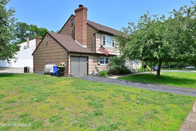 8 Michelle Ave, South Amboy, NJ 08879 - view of side of property featuring a garage, a shingled roof, a lawn, a chimney, and driveway