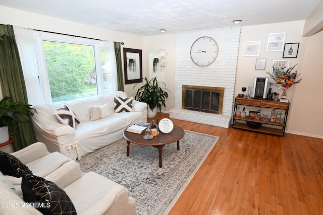 8 Michelle Ave, South Amboy, NJ 08879 - living area featuring a brick fireplace, light wood-style flooring, and baseboards
