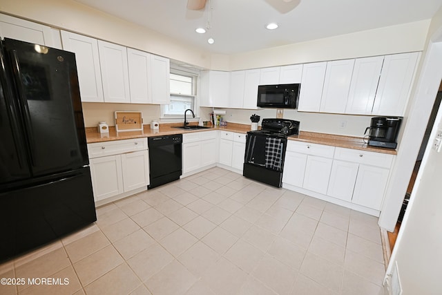 8 Michelle Ave, South Amboy, NJ 08879 - kitchen with black appliances, a sink, light countertops, light tile patterned flooring, and white cabinets