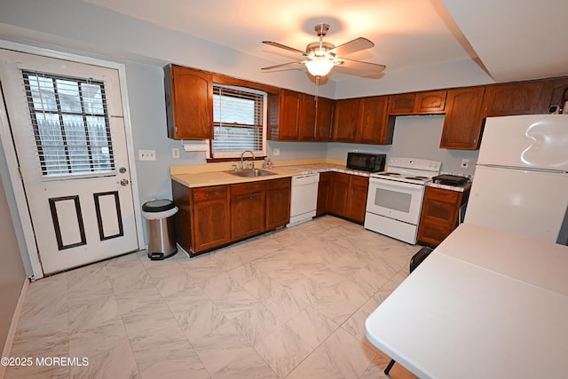 8 Michelle Ave, South Amboy, NJ 08879 - kitchen featuring white appliances, a sink, light countertops, a ceiling fan, and brown cabinetry
