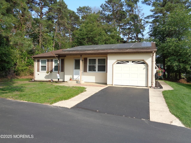 13 Berry Hill Rd, Whiting, NJ 08759 - view of front of home with an attached garage, roof mounted solar panels, a front yard, and driveway