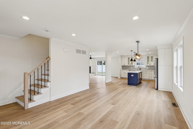 559 Holmdel Rd, Hazlet, NJ 07730 - unfurnished living room with crown molding, light wood-style floors, recessed lighting, stairs, and baseboards
