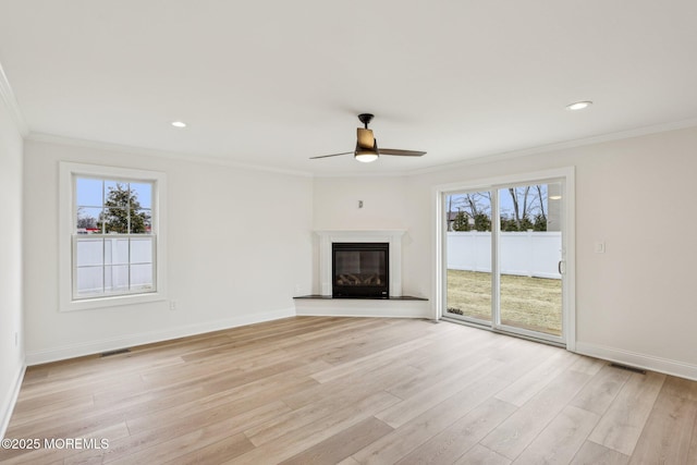559 Holmdel Rd, Hazlet, NJ 07730 - unfurnished living room with ornamental molding, ceiling fan, light wood finished floors, a glass covered fireplace, and baseboards