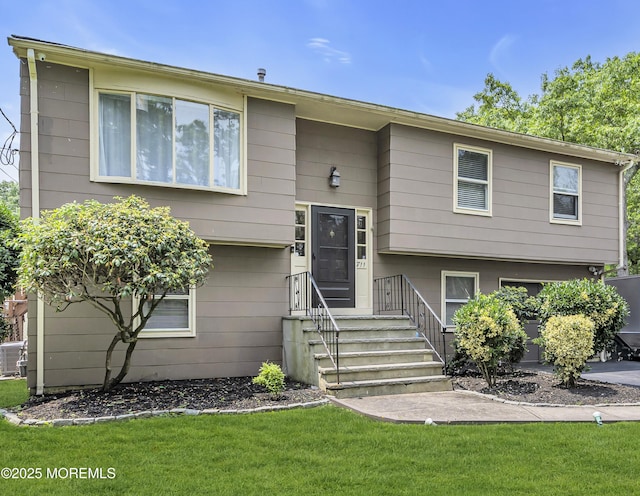 711 Chelsea St, Forked River, NJ 08731 - split foyer home featuring a front lawn and cooling unit