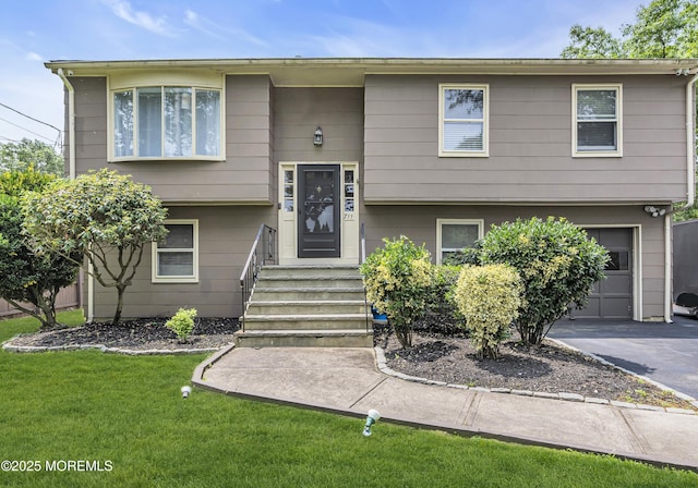 711 Chelsea St, Forked River, NJ 08731 - split foyer home featuring a garage, a front lawn, and asphalt driveway