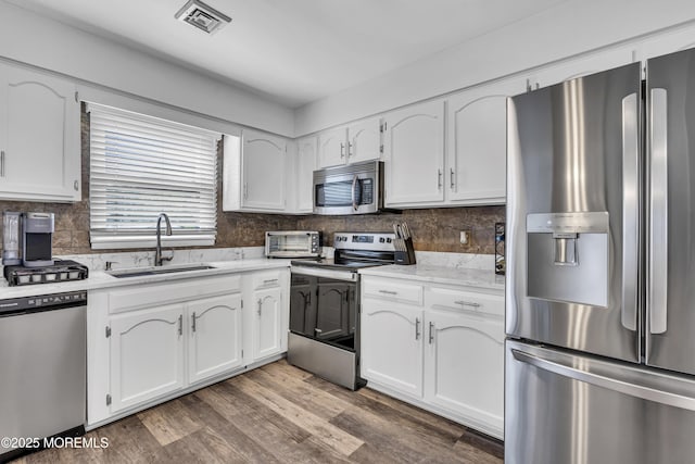 711 Chelsea St, Forked River, NJ 08731 - kitchen with appliances with stainless steel finishes, a sink, and white cabinetry