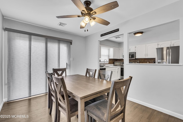 711 Chelsea St, Forked River, NJ 08731 - dining room with a ceiling fan, wood finished floors, and baseboards