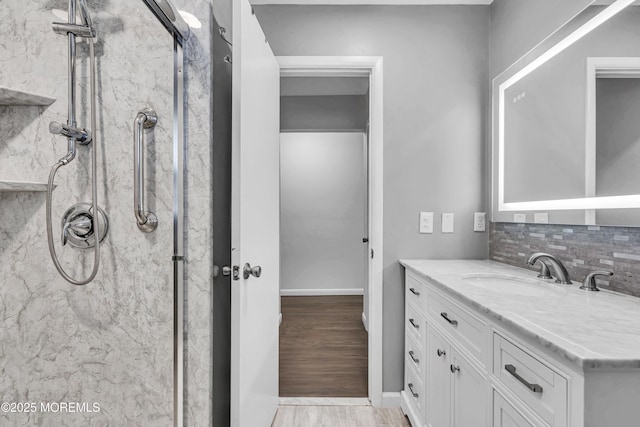 711 Chelsea St, Forked River, NJ 08731 - bathroom featuring a marble finish shower, vanity, decorative backsplash, and baseboards