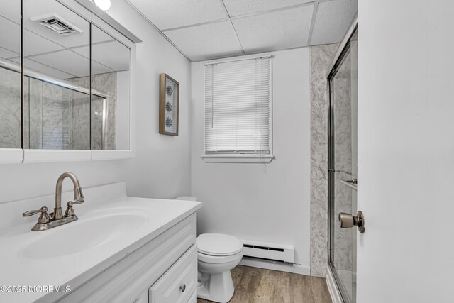 711 Chelsea St, Forked River, NJ 08731 - full bath featuring baseboard heating, a drop ceiling, vanity, a stall shower, and wood finished floors