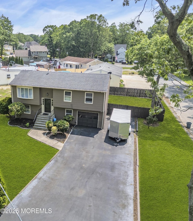 711 Chelsea St, Forked River, NJ 08731 - raised ranch featuring a garage, asphalt driveway, a residential view, and roof with shingles