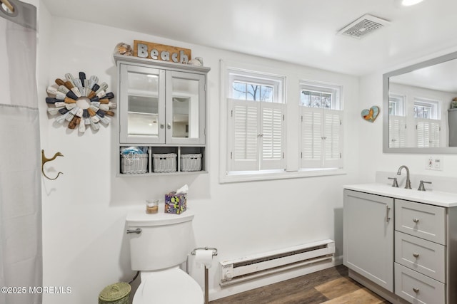 1592 W Front St, Lincroft, NJ 07738 - bathroom with baseboard heating, vanity, toilet, and wood finished floors