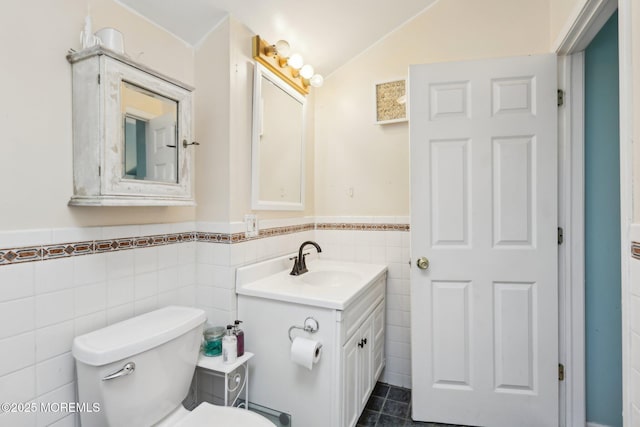 1592 W Front St, Lincroft, NJ 07738 - bathroom featuring vanity, toilet, a wainscoted wall, tile walls, and lofted ceiling