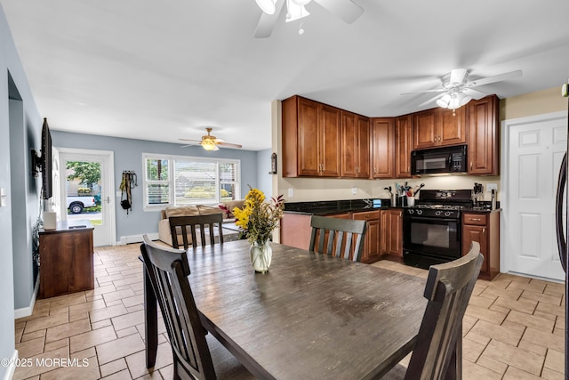 1004 Pensacola Rd, Forked River, NJ 08731 - kitchen with black appliances, a ceiling fan, and dark countertops
