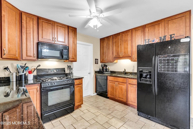 1004 Pensacola Rd, Forked River, NJ 08731 - kitchen with black appliances, ceiling fan, dark stone counters, and brown cabinetry