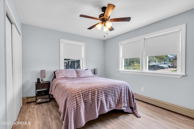 1004 Pensacola Rd, Forked River, NJ 08731 - bedroom with a baseboard radiator, wood finished floors, a ceiling fan, and a closet