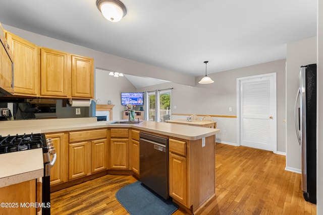 17 Durell Dr, Jackson, NJ 08527 - kitchen featuring stainless steel appliances, a peninsula, light countertops, vaulted ceiling, and wood finished floors