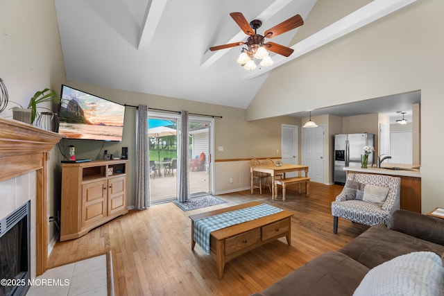 17 Durell Dr, Jackson, NJ 08527 - living area with high vaulted ceiling, light wood-type flooring, a ceiling fan, a fireplace, and baseboards