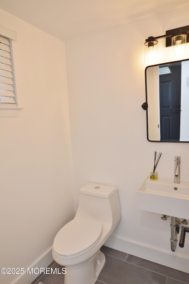 11 Fern Ct, Tinton Falls, NJ 07724 - half bathroom with toilet, baseboards, tile patterned flooring, and a sink