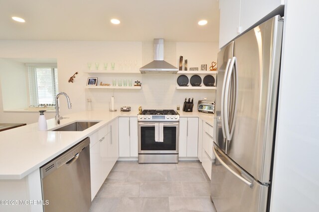 11 Fern Ct, Tinton Falls, NJ 07724 - kitchen with appliances with stainless steel finishes, open shelves, wall chimney range hood, a sink, and a peninsula