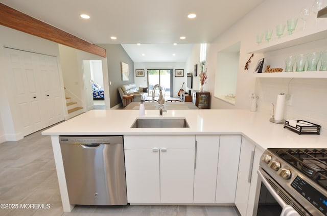 11 Fern Ct, Tinton Falls, NJ 07724 - kitchen with stainless steel appliances, a sink, a peninsula, light countertops, and white cabinets