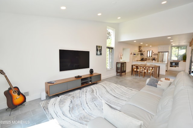 11 Fern Ct, Tinton Falls, NJ 07724 - living area with recessed lighting, healthy amount of natural light, lofted ceiling, baseboards, and light tile patterned flooring