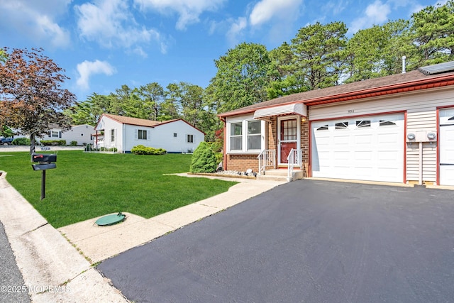53A Milford Ave Unit A, Whiting, NJ 08759 - view of front of home featuring a front yard, asphalt driveway, brick siding, and a garage