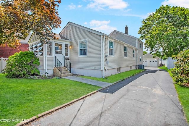 81 Curtis Pl, Manasquan, NJ 08736 - view of front of property with entry steps, a garage, a chimney, and an outbuilding