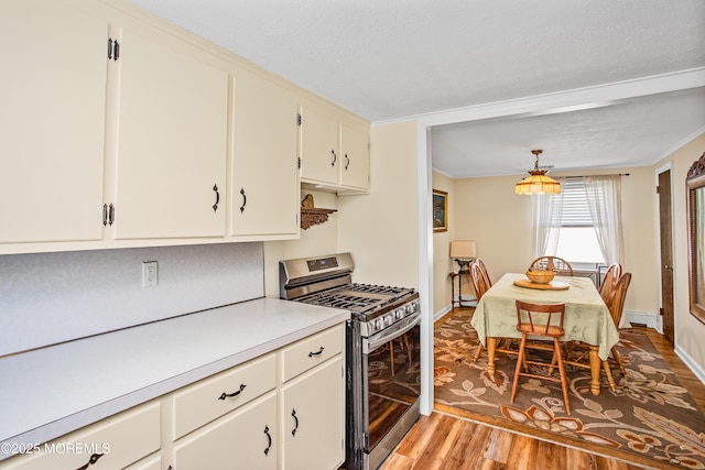 81 Curtis Pl, Manasquan, NJ 08736 - kitchen featuring stainless steel gas range oven, light wood-type flooring, light countertops, a baseboard radiator, and baseboards