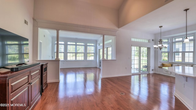 38 Ocean Grove Ln, Waretown, NJ 08758 - kitchen with healthy amount of natural light, a chandelier, wood finished floors, open floor plan, and a high ceiling