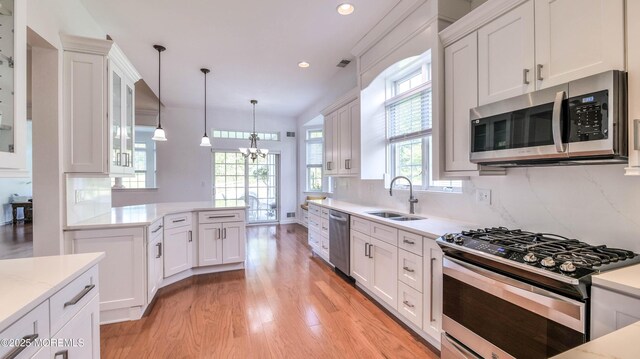 38 Ocean Grove Ln, Waretown, NJ 08758 - kitchen featuring appliances with stainless steel finishes, a sink, light wood finished floors, white cabinets, and recessed lighting