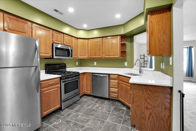 503 Oswego Ct, Mount Laurel, NJ 08054 - kitchen featuring stainless steel appliances, light countertops, open shelves, brown cabinets, and dark marble finish flooring