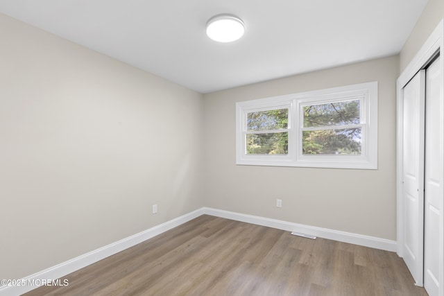 13 Pinehurst Dr, Little Egg Harbor, NJ 08087 - unfurnished bedroom featuring a closet, wood finished floors, and baseboards