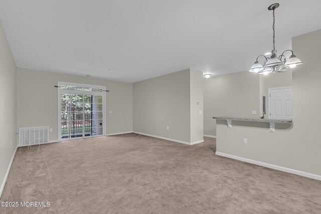 113 Sophee Ln, Lakewood, NJ 08701 - unfurnished living room featuring carpet, a chandelier, and baseboards