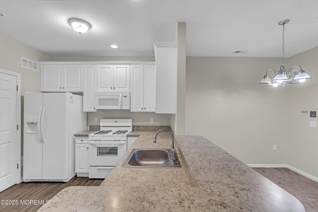 113 Sophee Ln, Lakewood, NJ 08701 - kitchen with white appliances, a sink, white cabinetry, a chandelier, and decorative light fixtures