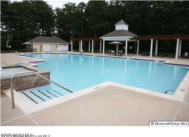 113 Sophee Ln, Lakewood, NJ 08701 - community pool featuring a gazebo, a patio, and view of scattered trees
