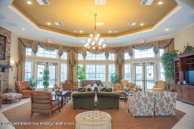 113 Sophee Ln, Lakewood, NJ 08701 - living room with a raised ceiling, a high ceiling, plenty of natural light, ornamental molding, and french doors