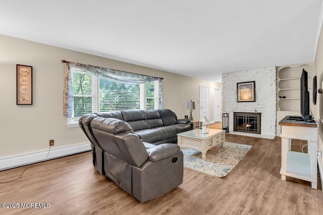 7 E Parkway Pl, Holmdel, NJ 07733 - living room featuring a fireplace, wood finished floors, and baseboards