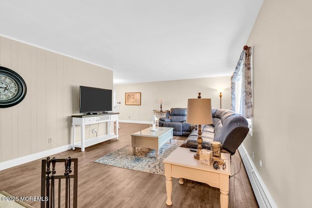 7 E Parkway Pl, Holmdel, NJ 07733 - living room with wood finished floors, baseboards, and a baseboard heating unit