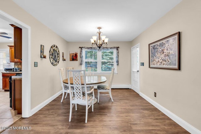 7 E Parkway Pl, Holmdel, NJ 07733 - dining room featuring a chandelier, healthy amount of natural light, baseboards, and light wood-style flooring